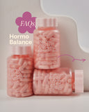 Pink 'Hormo Balance' supplement bottles with a white background