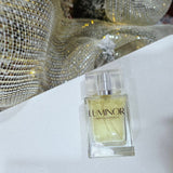 Luminor perfume bottle on a white surface with decorative background