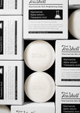 TeaShell Niacinamide Skin Brightening Soap shown with its white and black packaging boxes, featuring two round white soap bars and multiple cartons arranged in a clean grid.